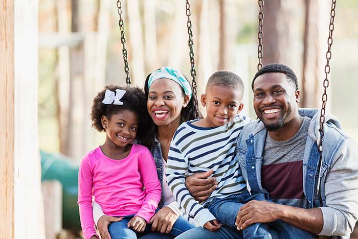 couple with their kids smiling
