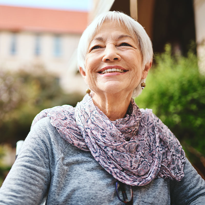 Happy elderly woman smiling outdoors