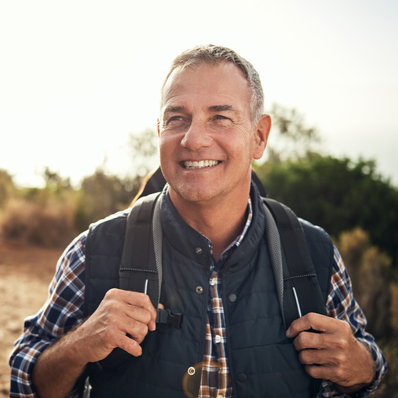 Happy man hiking and smiling