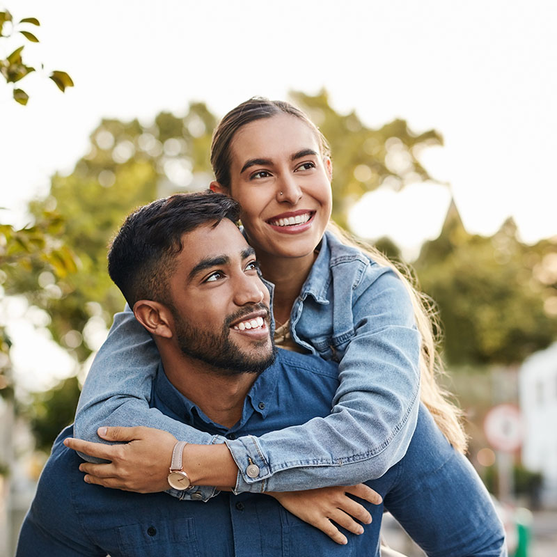 Happy couple smiling and enjoying the day outdoors