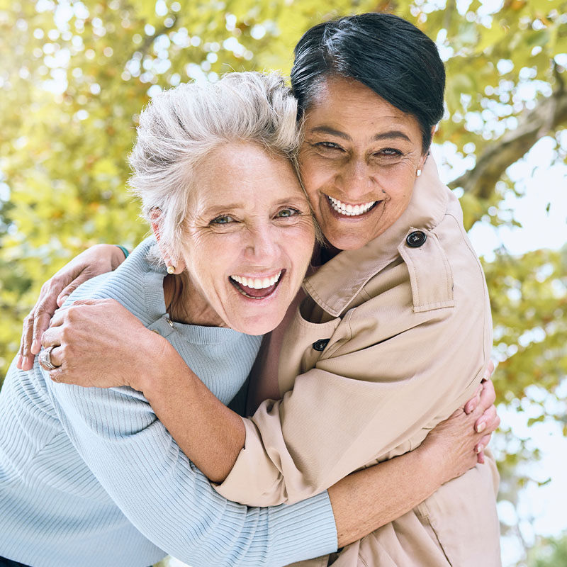two friends happily smiling