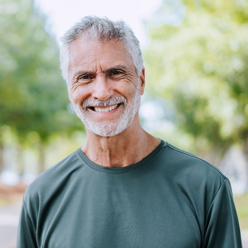 Happy elderly man smiling outdoors