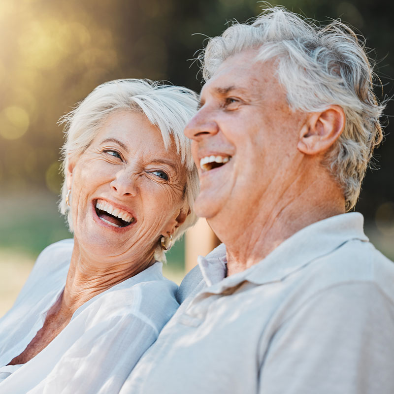 Happy elderly couple smiling outdoors