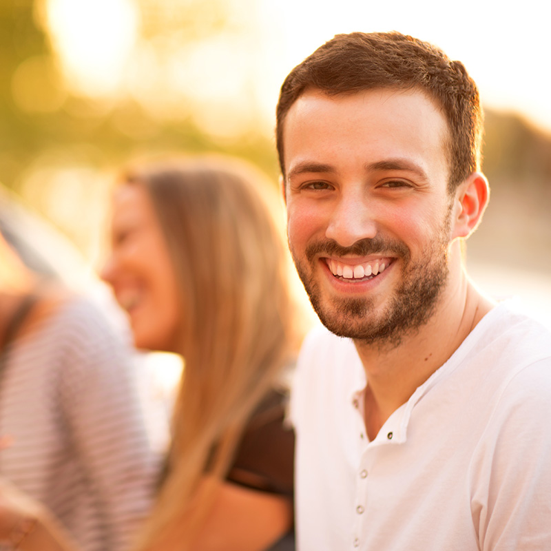 Smiling friends with a focus on the man in front