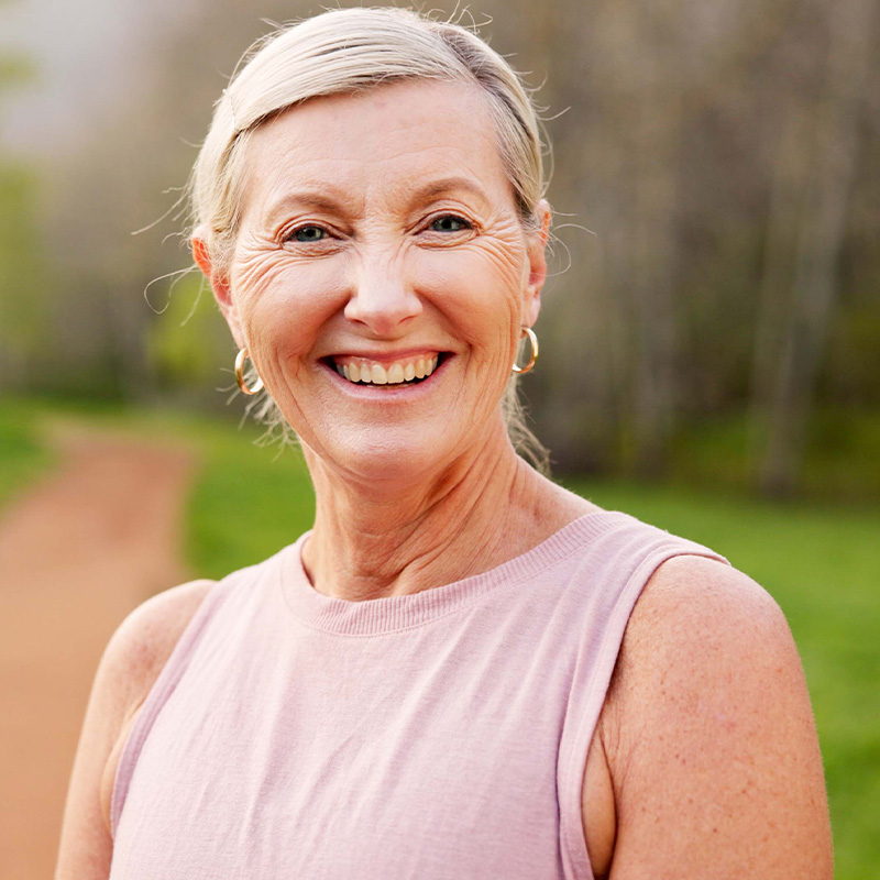 Happy elderly woman smiling outdoors