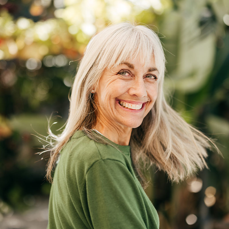 Elderly woman smiling outdoors