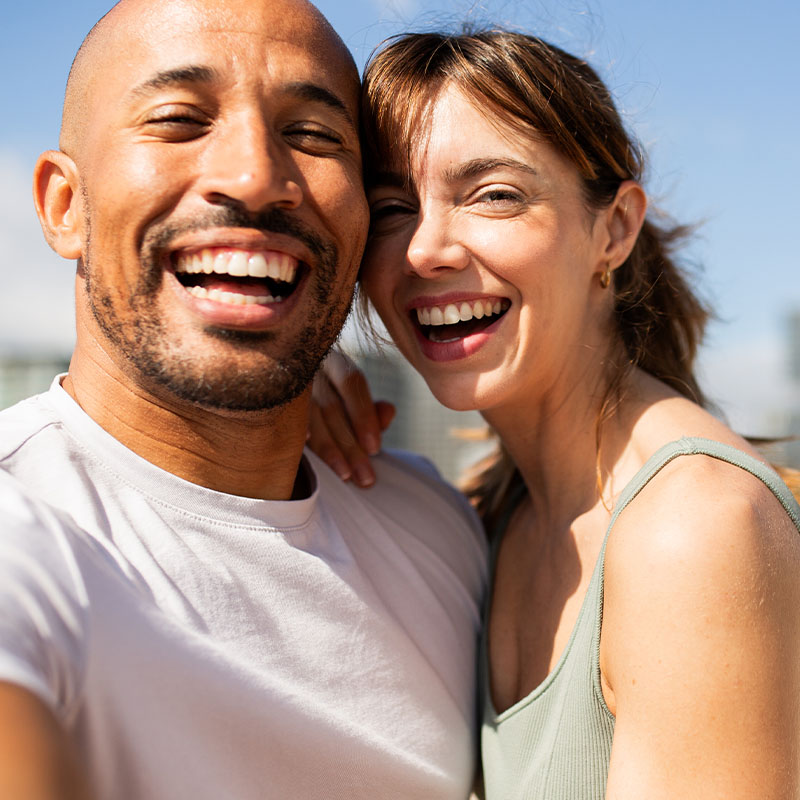 Happy couple smiling having fun outdoors