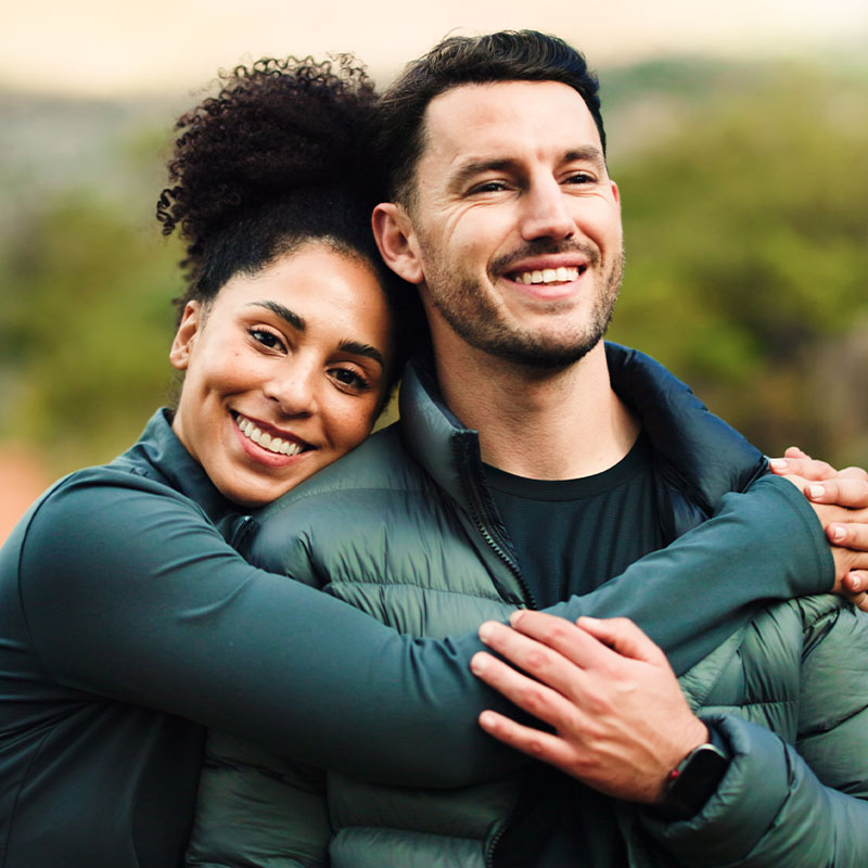 Happy, hug and hiking with couple in nature for fitness