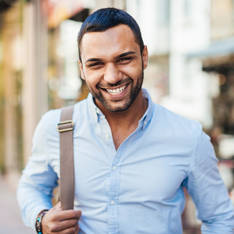 Cheerful young man walking on the street