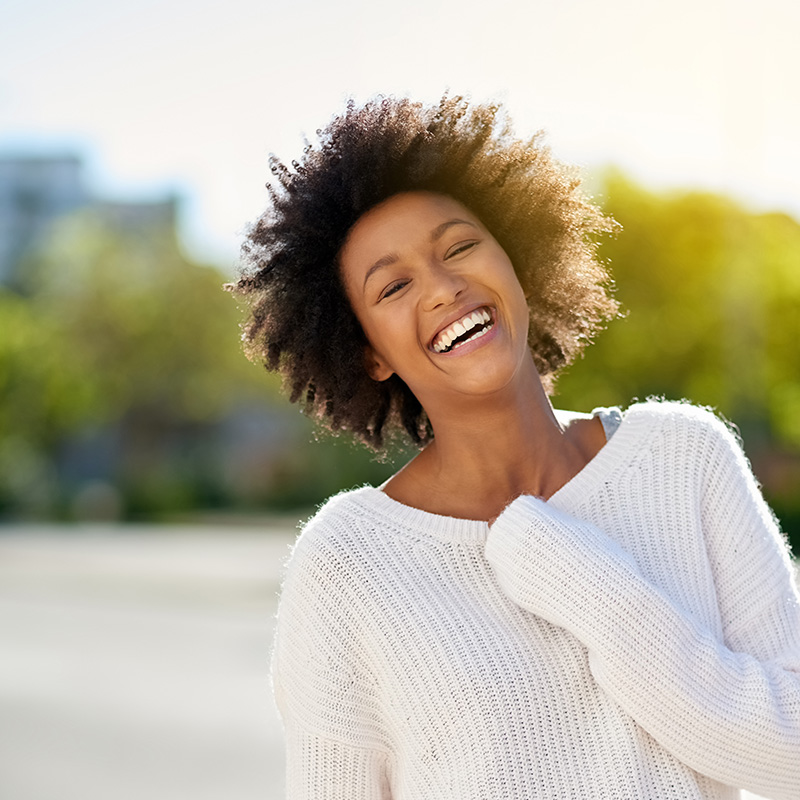 Shot of a happy young woman going in the city